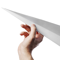 A hand throwing a paper airplane, representing the idea of a paper airplane contest.