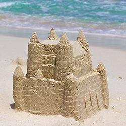 A sandcastle on a beach, representing a sandcastle contest fundraiser.